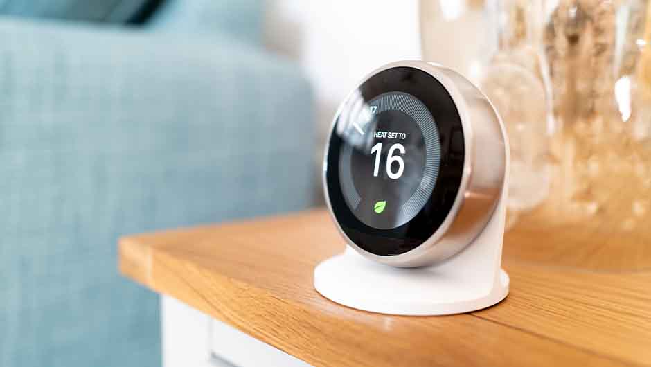 Person adjusting smart thermometer Person adjusting smart thermometer