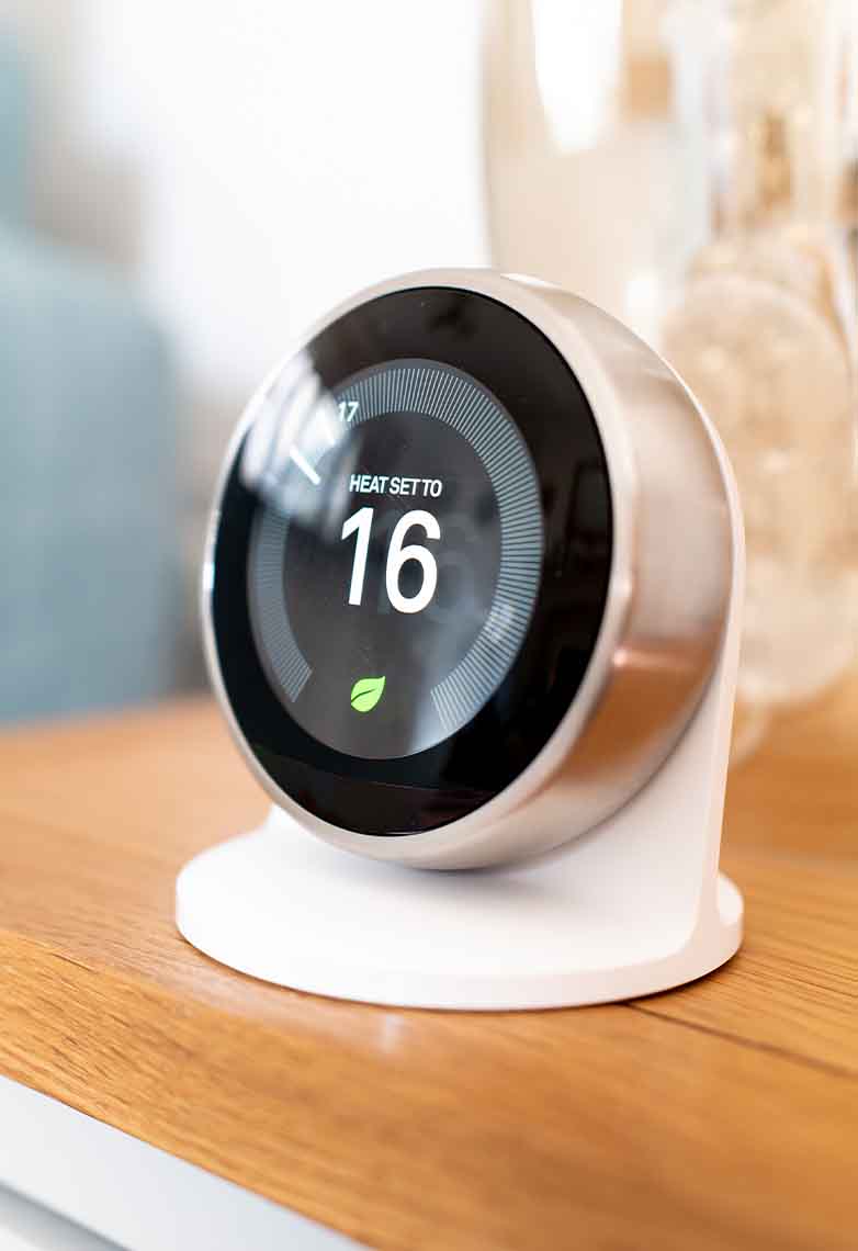 Person adjusting smart thermometer Person adjusting smart thermometer