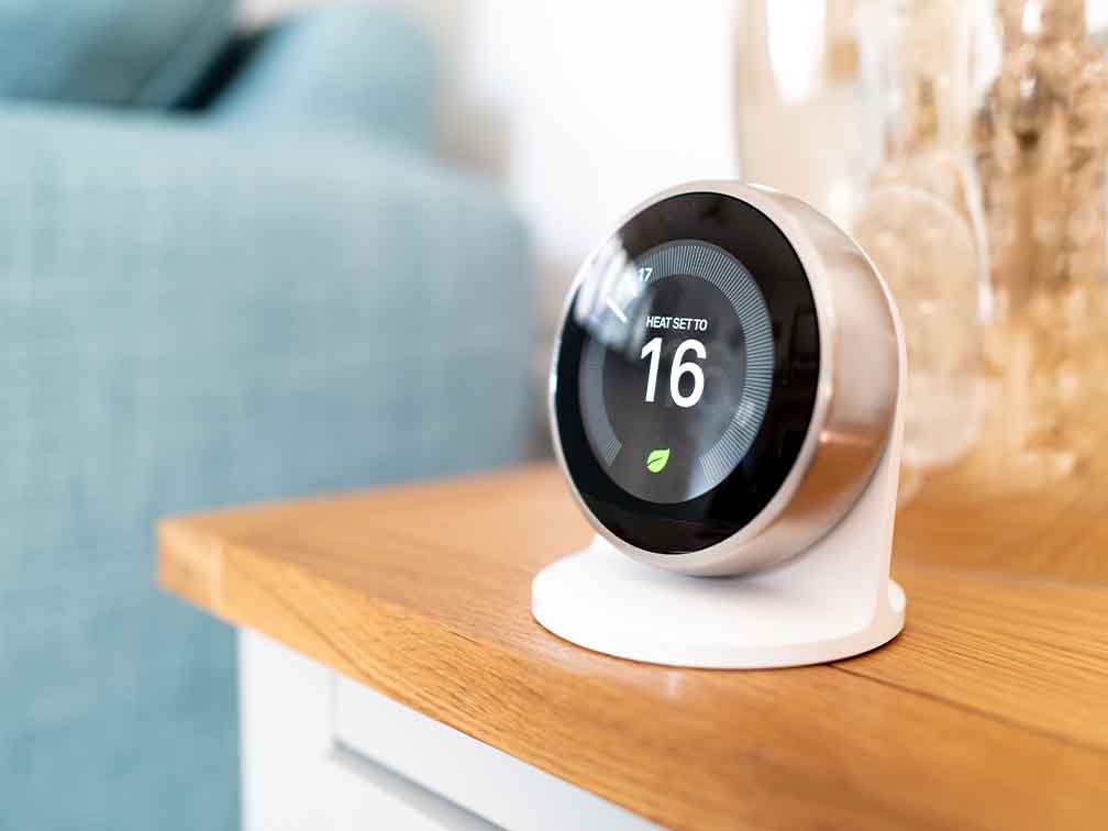 Person adjusting smart thermometer Person adjusting smart thermometer