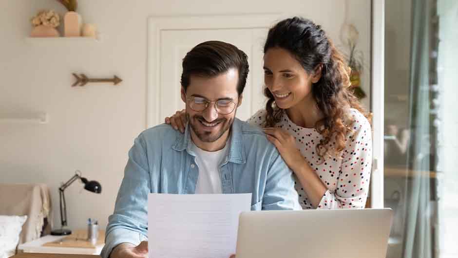 Husband and wife smiling at letter Husband and wife smiling at letter