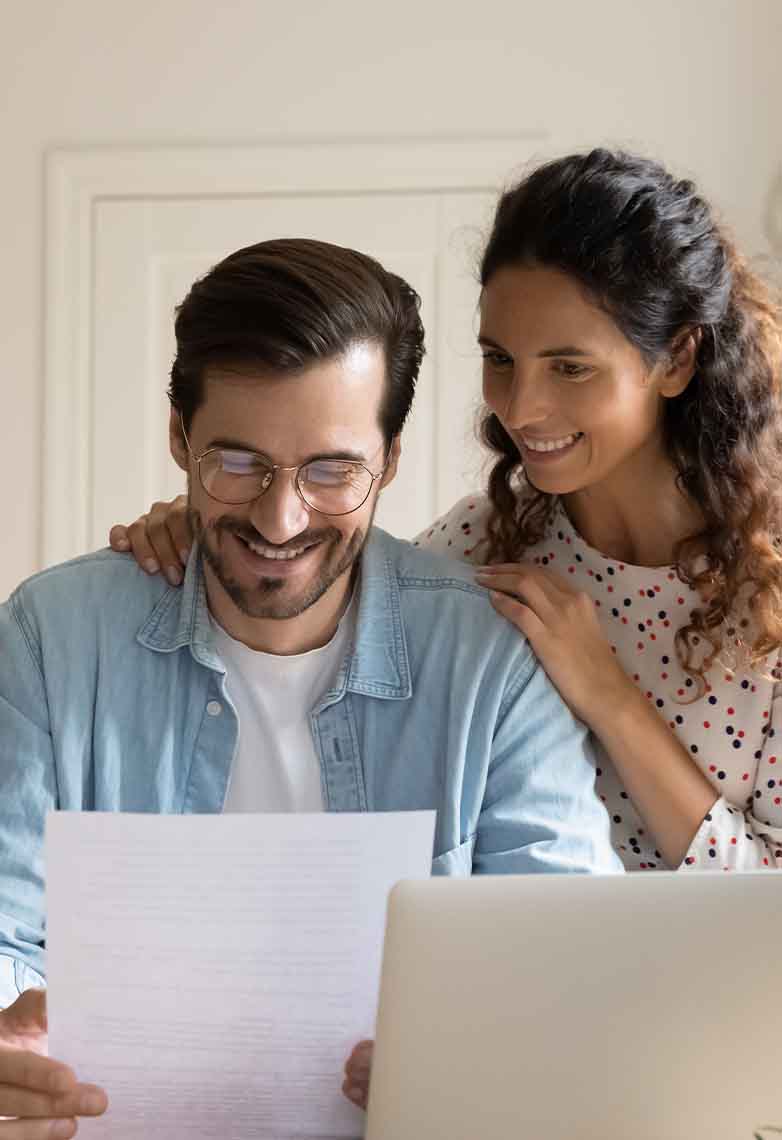 Husband and wife smiling at letter Husband and wife smiling at letter