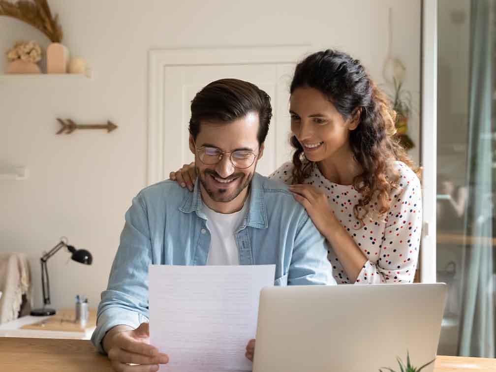 Husband and wife smiling at letter Husband and wife smiling at letter