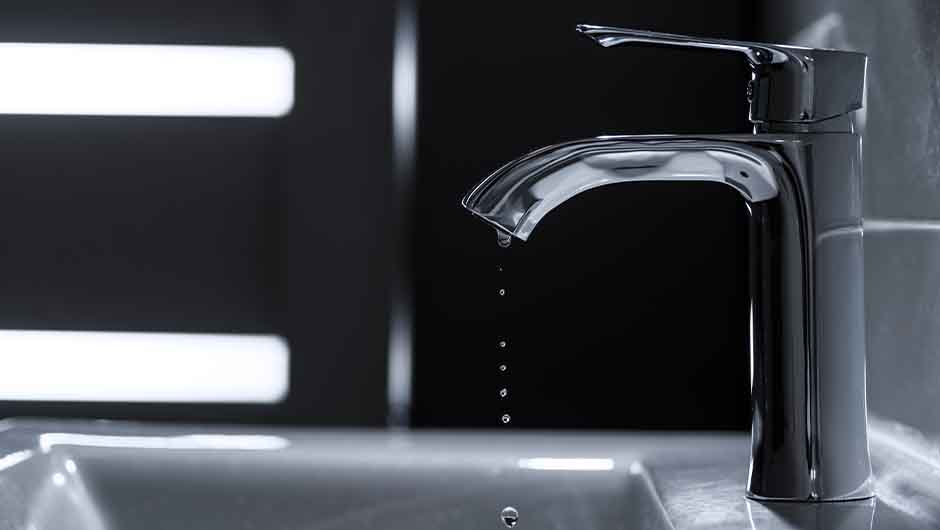 Modern silver tap dripping water