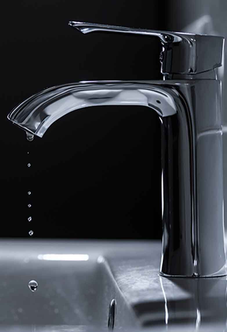 Modern silver tap dripping water