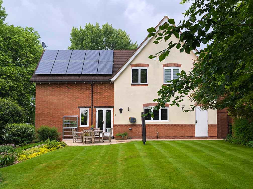 A country side house with solar panels on its roof