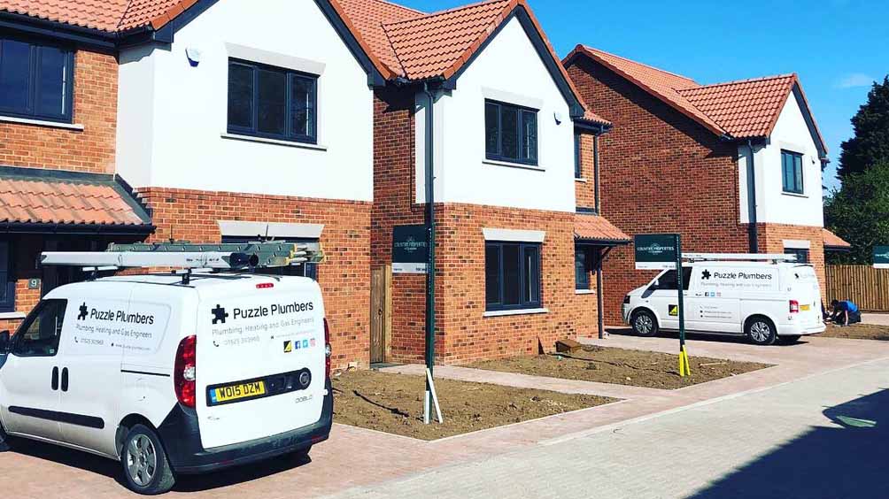Puzzle Plumbers vans outside new builds Puzzle Plumbers vans outside new builds